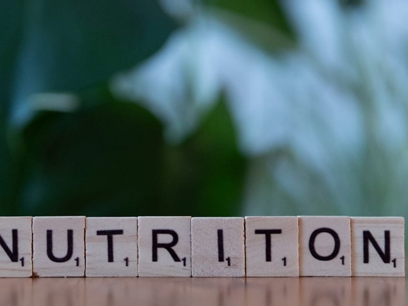 A wooden block spelling nutrition on a table