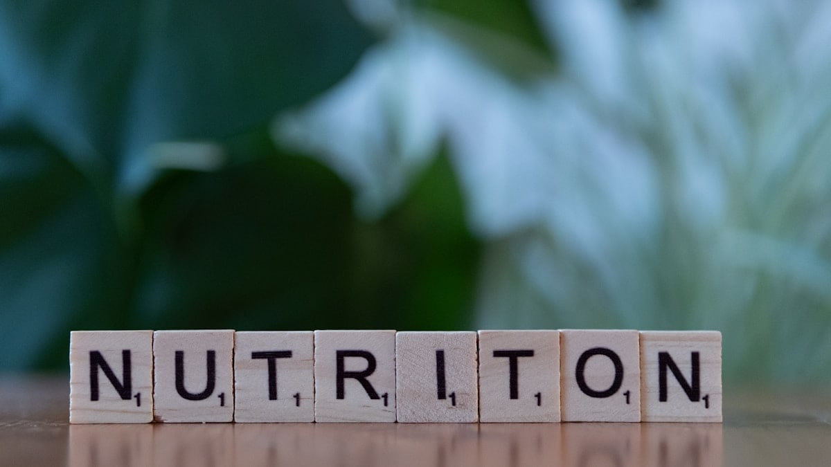 A wooden block spelling nutrition on a table