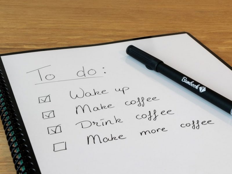 a notepad with a pen on top of it