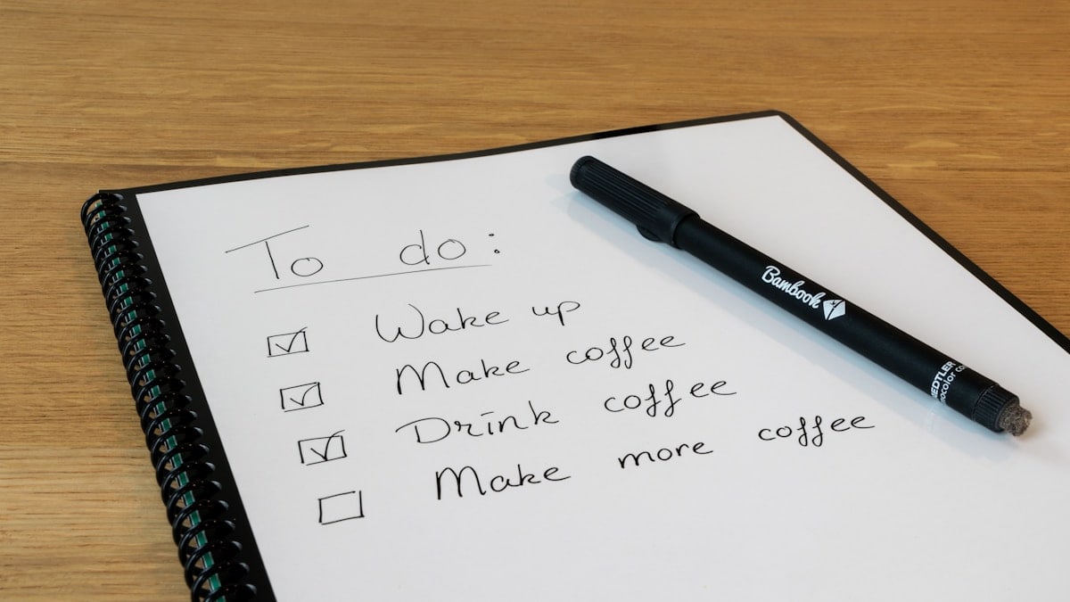 a notepad with a pen on top of it
